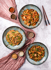 Asian food table with various kind of chinese noodles with chicken, pork, beef and others