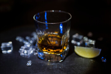 drink alcohol whiskey or rum in a glass glass with ice