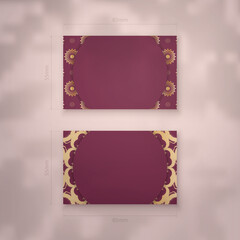 Visiting business card in burgundy color with mandala gold ornament for your contacts.