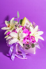 A beautiful bouquet of fresh flowers on a violet background