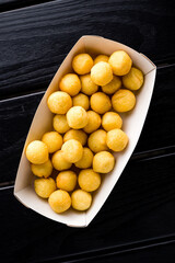Deep fried cheese and potato balls on the black background