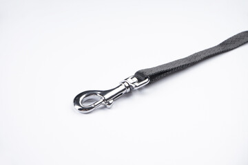 Dog leash with carabiner on a white background, close-up.