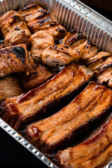 set of grilled ribs and BBQ meat in a delivery box