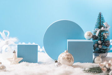 Winter Christmas composition with geometric shapes podiums and christmas decorations on blue...