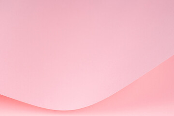 Abstract wave of pastel pink paper. Creative geometric curved paper with light and shadows. Abstract monochrome background with copy space