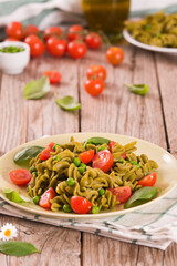 Fusilli pasta with cherry tomatoes and peas.
