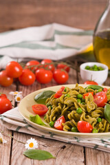 Fusilli pasta with cherry tomatoes and peas.
