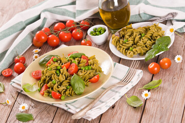 Fusilli pasta with cherry tomatoes and peas.
