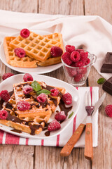 Waffles with raspberries and chocolate cream.