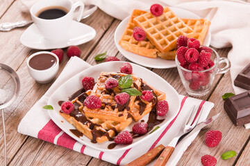 Waffles with raspberries and chocolate cream.