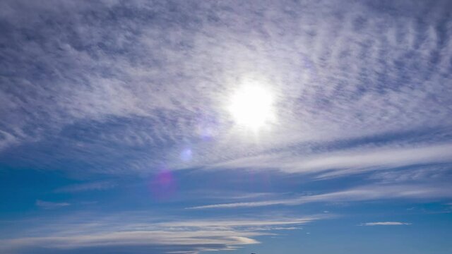 heavenly blue sky white cirrus cloud skyscape timelapse in bright clear sunny summer season, rays, sunbeams lens flare beauty light. Sunstar 4k resolution. sky sunlight shine in wide nature background
