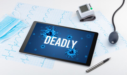 Tablet pc and doctor tools on white surface
