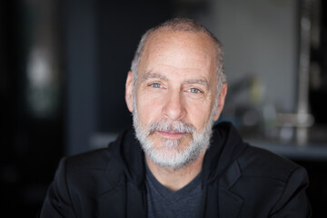 Serious Old Man looking At The Camera. With a gray beard. Sadness. Bad day at the office