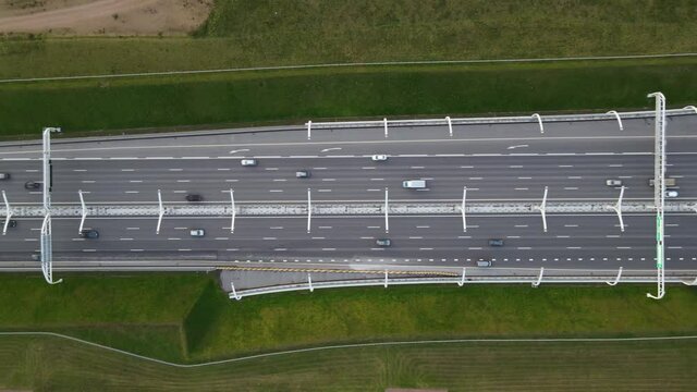 Top-down view on multilane highway. A lots of cars moving fast on road. Western High-Speed Diameter, ZSD.