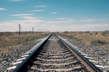 Fototapeta na wymiar Railway rails in the desert. Horizontal photo. High quality photo