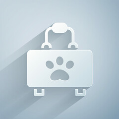 Paper cut Pet first aid kit icon isolated on grey background. Dog or cat paw print. Clinic box. Paper art style. Vector