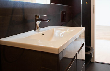 modern bathroom with dark furniture and spotlights