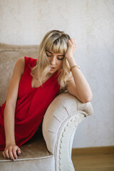 Naklejka premium Portrait of beautiful blond young woman wearing red dress