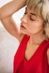 Portrait of beautiful blond young woman wearing red dress