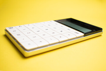 Modern calculator, Business and Finance accounting concept on yellow background with space for text.