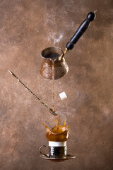 levitating coffee and turk on brown background. Splashes of coffee. turkish coffee.