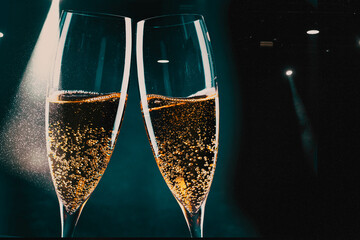 two glasses of champagne and holiday lights - new year celebration