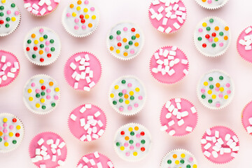 Colorful cupcakes on a white background.