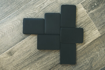 Many portable hard drives on the wooden floor. Mosaic of usb storage devices. External computer...