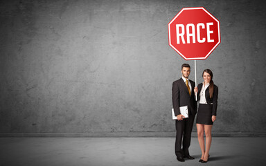 Young business person holding road sign