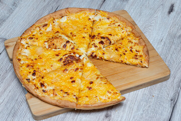 pizza served on a table with a slice taken