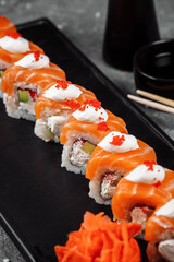 Philadelphia roll sushi with salmon, smoked eel, cucumber, avocado, cream cheese, red caviar. Sushi menu. Japanese food