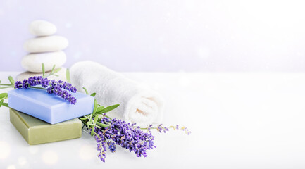 Wellness, relax, massage and wellbeing concept. Spa stones and orchid flower over light pink and...