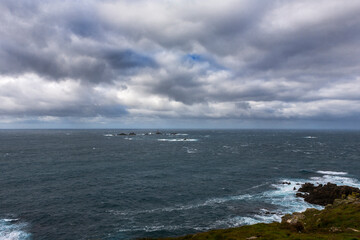 Gale-force conditions at Longships lighthouse off Land's End, Cornwall, UK