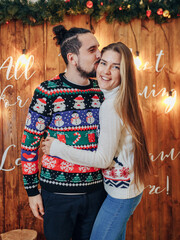 a couple of lovers hugging in New Year's sweaters before Christmas