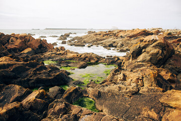 Fototapeta na wymiar Rocks by the ocean in Porto, Portugal