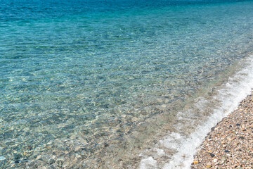 Fototapeta na wymiar Pristine and calm Mediterranean sea water next to the shoreline, Sicily
