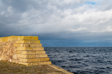 BUCKIE, MORAY, SCOTLAND - 19 NOVEMBER 2021: This is the sun shining on the old parts of Buckpool Harbour within Buckie, Moray, Scotland on 19 November 2021.