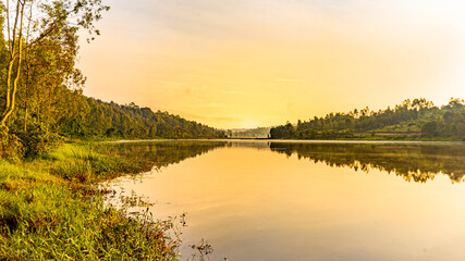 Fototapeta na wymiar morning golden sunrise over the river with reflection