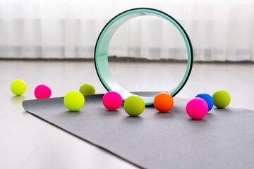 Colored Myofascial release massage balls and yoga ring other body roll recover on gray mat