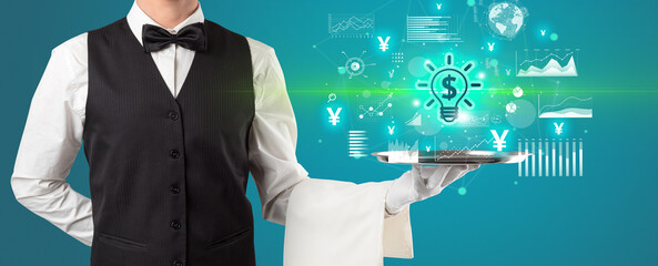 Handsome young waiter in tuxedo holding currency icons on tray