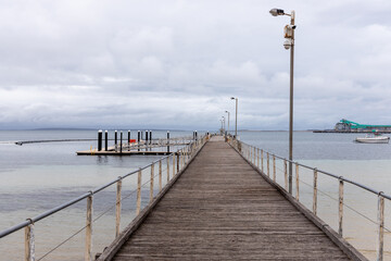 The Port Lincoln jetty with Brennans wharf in the background located in Port Lincoln South Australia on November 19th 2021