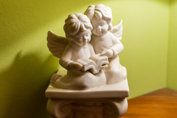 Angels with book on a column