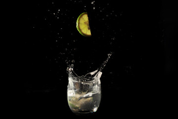 lime dropping into cocktail