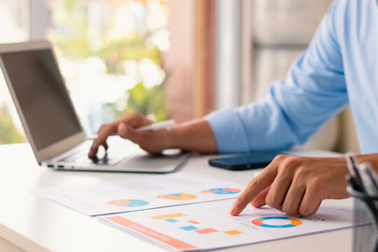 Businessman analysis business report graph and finance chart at Coffee Shop, conceptual of finance economy, stock market research, and banking business. - Powered by Adobe
