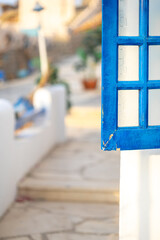 White and blue architecture on Santorini island on blurred background Traditional greek house and church in selective focus. Vacation and travel concept. Vertical photo