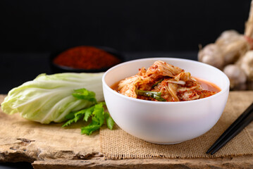 Korean kimchi cabbage in a bowl on wooden, Asian fermented food