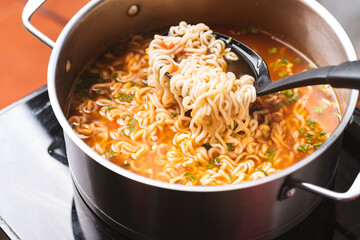 Asian spicy instant noodles soup cooking in hot pot