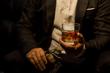 Closeup businessmen holding a glass of whiskey