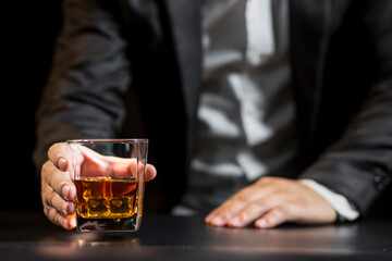 Closeup businessmen holding a glass of whiskey