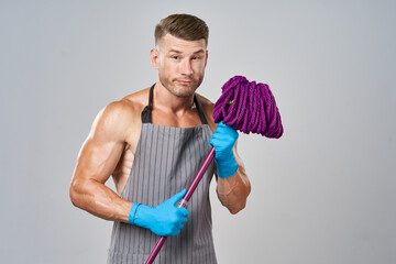 a man with a mop in his hands cleaning service posing